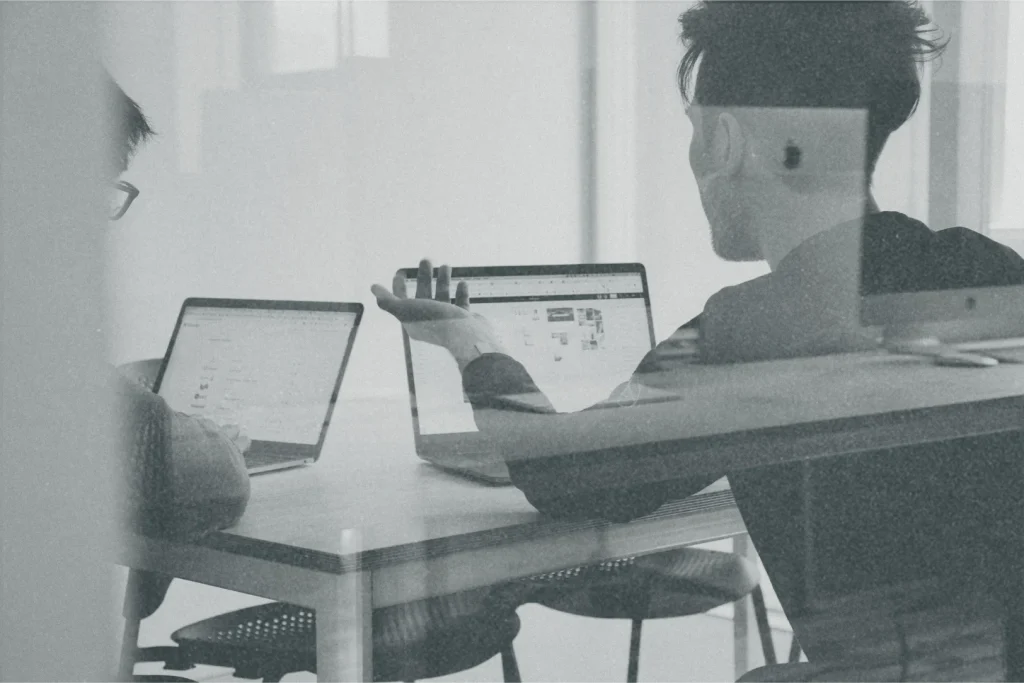 An image of two men in an office working on a website.