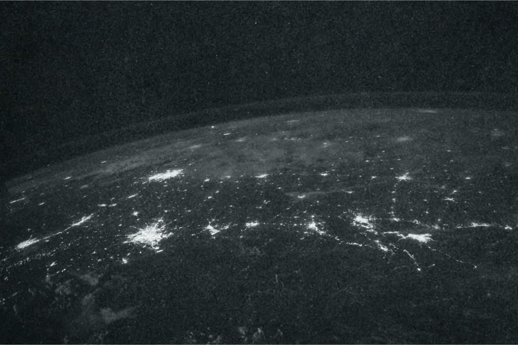 An image of the world viewed from space with interconnected lights visible.